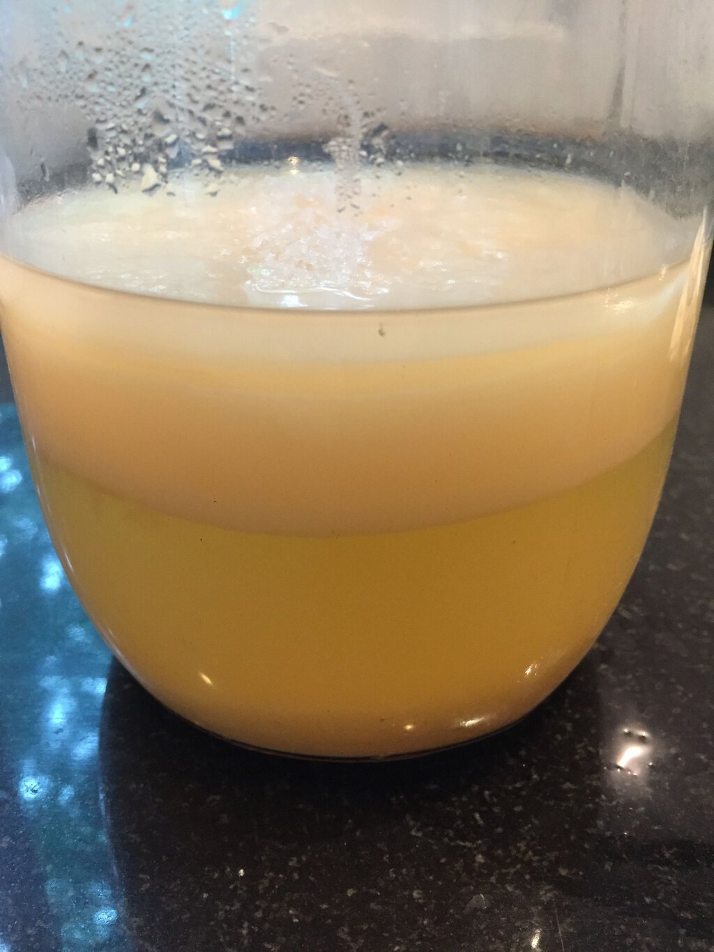 Apple cider vinegar, with mother on top, prior to bottling